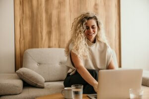 woman smiling on a computer